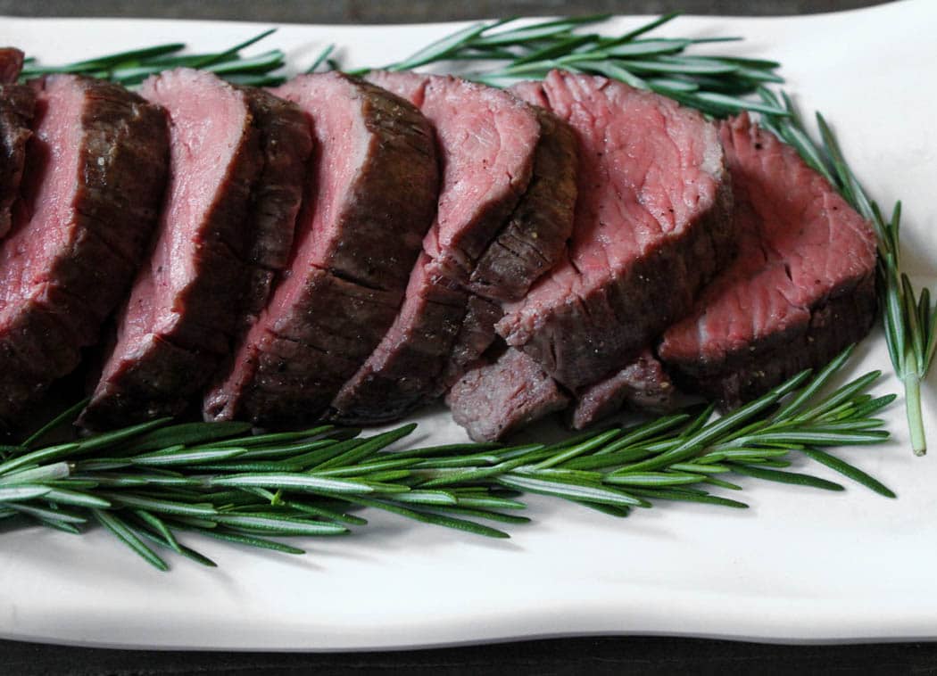 Close up up sliced slow-roasted beef tenderloin ready to be served.