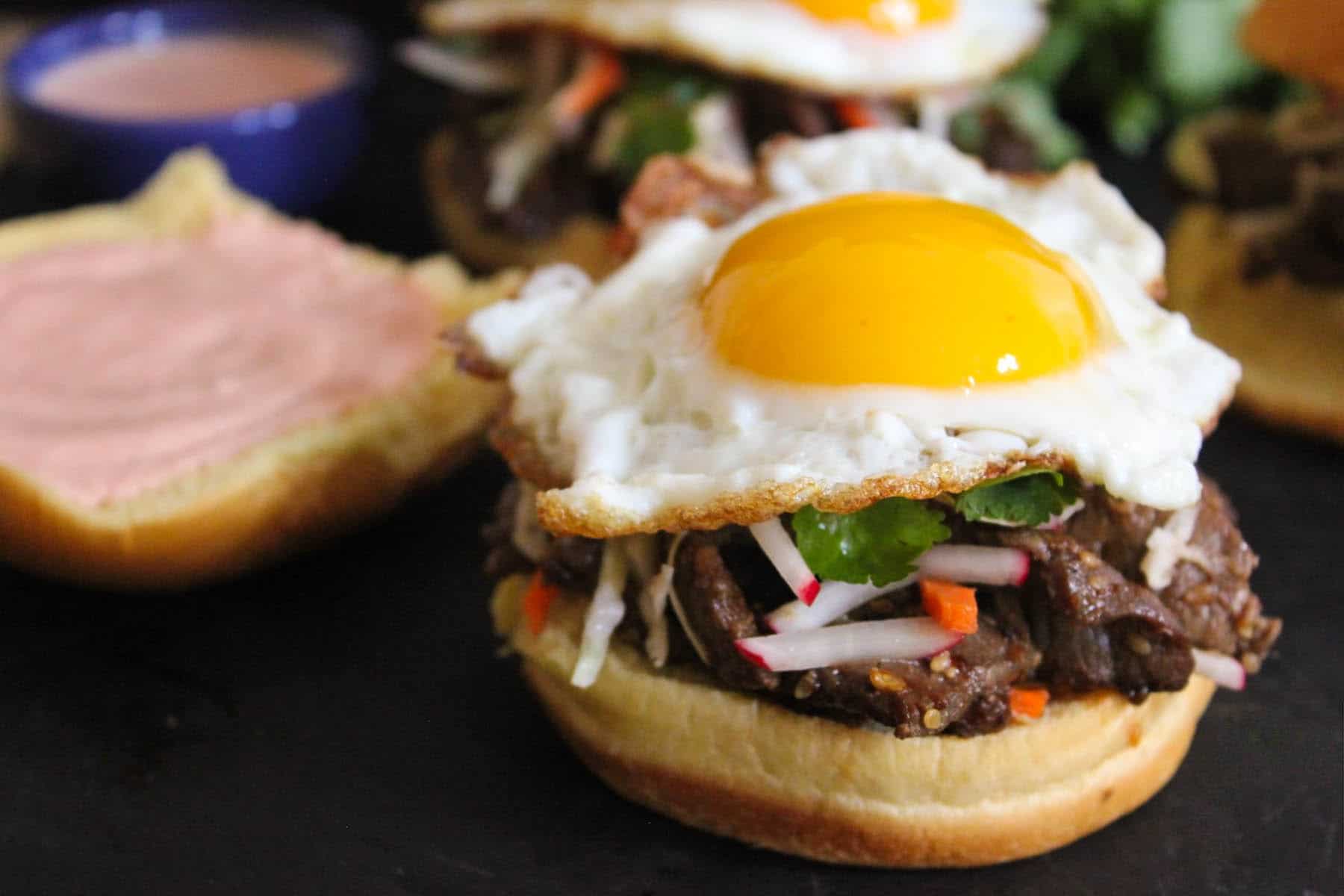 korean-steak-bulgogi-sandwiches-with-slaw-creamy-spicy-sauce-fried-eggs-9